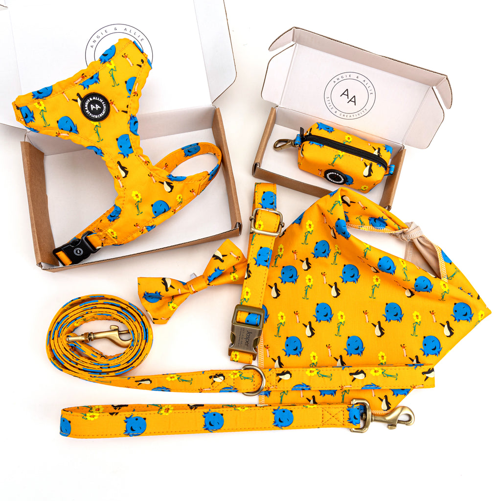 Yellow dog collar, leash, bag  and other accessories with Oswald patterns on a white background.