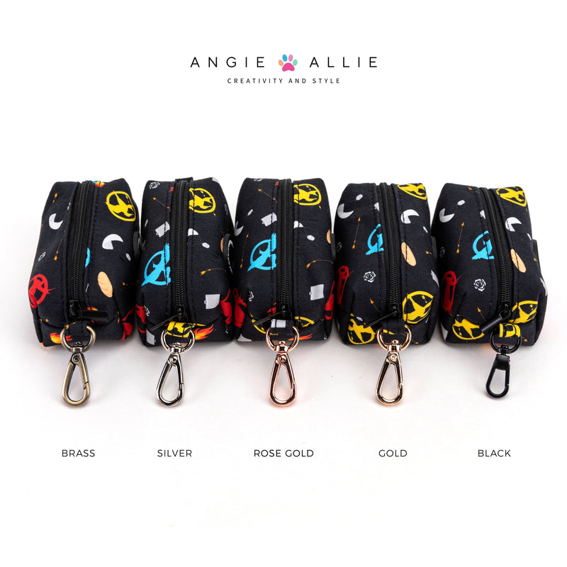 Set of poop bags with brass, silver, rose gold, gold, black hardwares on a black background, featuring the brand 'Angie Allie'